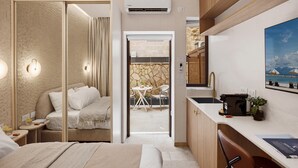 Una habitación de hotel moderna con cama, mesita de noche y vistas a un comedor.