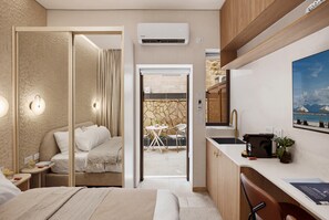 A modern hotel room with a bed, bedside table, and a view of a dining area. - Baraca Boutique- Apartments in Jerusalem (Jerusalem)