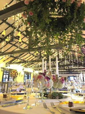 A banquet hall with tables set for a formal event, featuring floral centerpieces and string lights. - Hospederia y Centro de Convenciones Duruelo (Villa de Leyva)