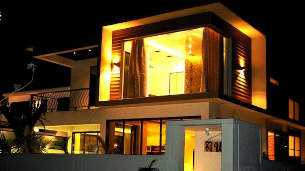 A modern two-story building with large windows and a balcony. - 23 West, Malavli (Pune)