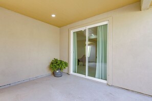 A balcony with a potted plant, a sliding glass door, and a ceiling light. - Brownsville Home: 9 Mi to Downtown! (Brownsville)