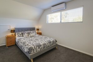 A bedroom with a bed, bedside tables, an air conditioner, and a window with blinds. - `Dunsborough`s Doorstep` Townhouse Great Location (Dunsborough)