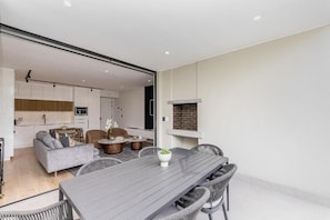 A modern interior with a dining area, kitchen, and living space. - Superior One-Bedroom Garden - Unit 4 (Stellenbosch)