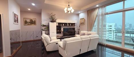 A modern living room with a sofa, a TV, and a decorative cabinet.