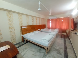 A hotel room with a wooden bed, a desk, and a chair.