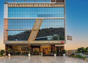 A hotel with a glass facade, a banquet hall, and a restaurant.