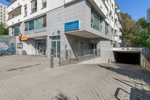 A modern building with a blue sign indicating a medical facility. - Lumina Premium 3-room Apart w/ Parking & Balcony (Warszawa)