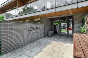 A building entrance with a brick wall and a sign that reads 'WAWA - WSKA Residence.'