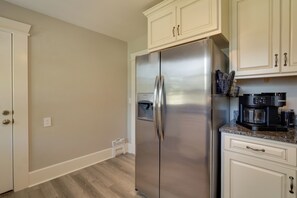 A kitchen with a stainless steel refrigerator, a coffee maker, and a water dispenser. - 'Olive & Oak' Mid-Century Sedalia Home w/ Patio (Sedalia)