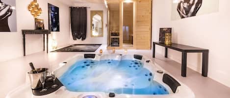 A spa room with a hot tub, a wooden cabinet, and a mirror.