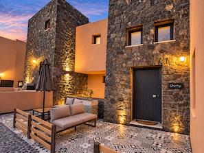 A stone building with a dark door and a sign reading 'Symphony.'