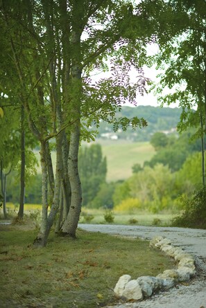 A natural landscape with trees, a grassy area, and a stone path. - Holiday Home 'Sautou' with Private Pool, Private Terrace and Wi-Fi (Penne-d'Agenais)