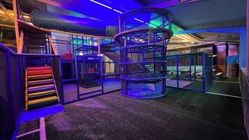 A play area with a spiral slide and climbing structures.