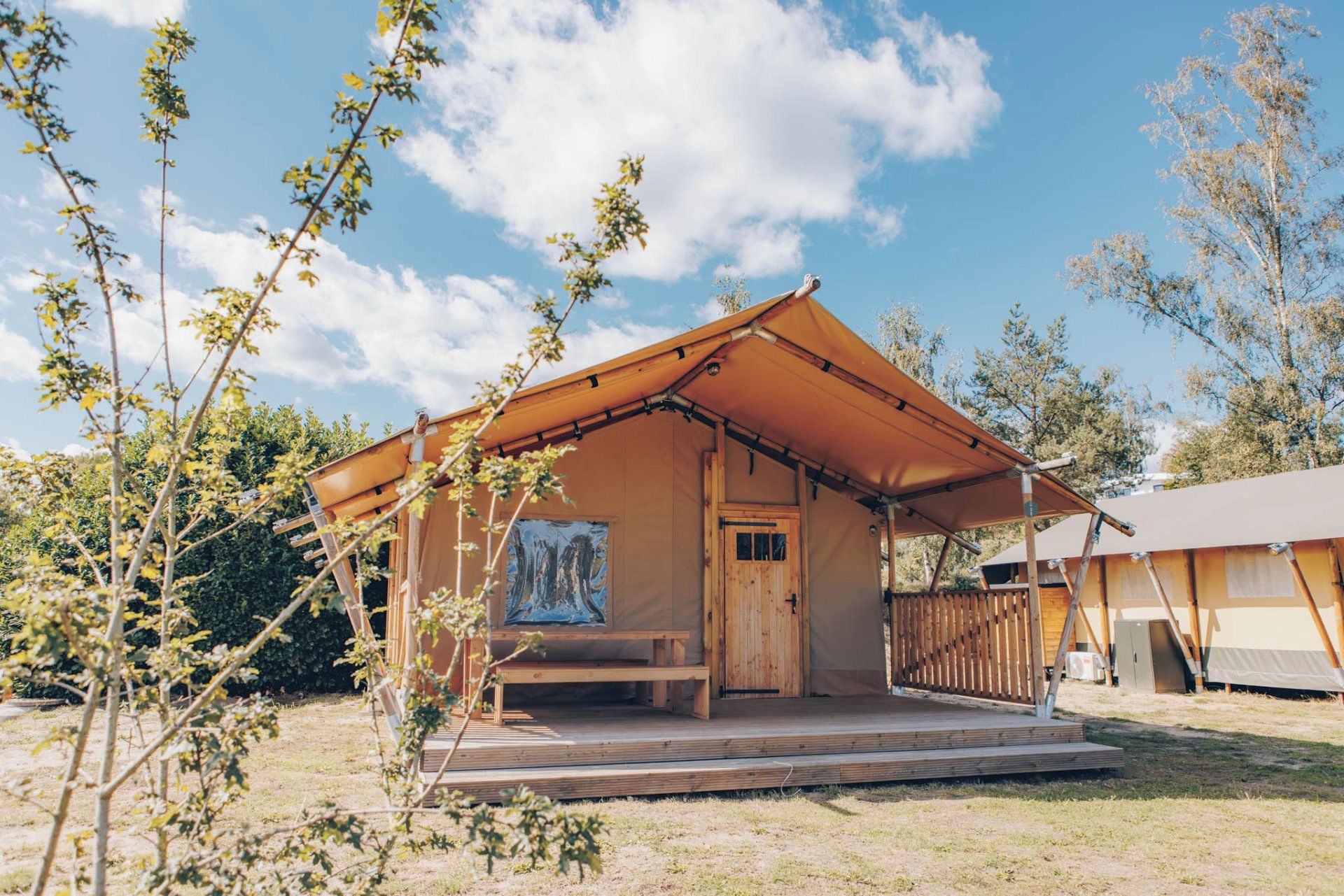 A wooden cabin with a porch and a covered entrance.