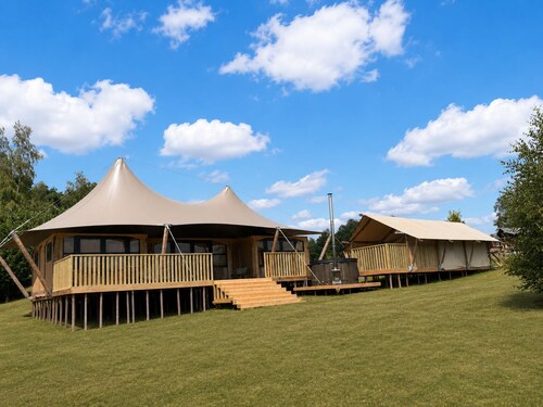 Enjoy luxury and togetherness? Stay in the Glamfield Lodge Deluxe with hot tub for 6 people, including a bell tent and views over the lake.