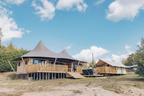 Enjoy luxury and togetherness? Stay in the Glamfield Lodge Deluxe with hot tub for 6 people, including a bell tent and views over the lake.