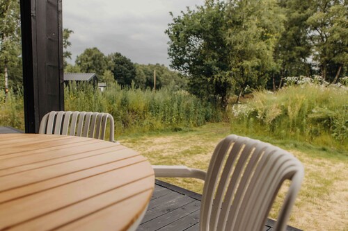 Enjoy a relaxing stay in an eco-friendly home with a hot tub and secluded location. The green sedum roof provides a natural look and sustainable insulation.