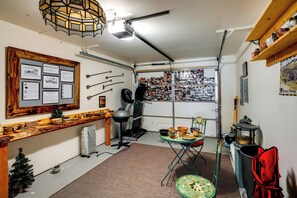 A compact kitchen with a dining area, a small Christmas tree, and a window with a view. - Walk to Yellowstone River! Emigrant Home w/ Patio (Emigrant)
