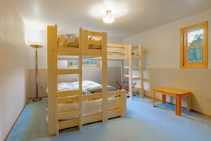 A bunk bed room with a desk and a lamp. - Riverfront Group Getaway Near Glacier NP (Columbia Falls)