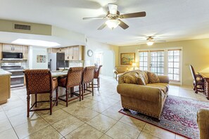 A spacious living area with a dining table, chairs, a sofa, and a ceiling fan. - Home w/ Fenced Yard! 2 Mi to Dtwn Casa Grande (Casa Grande)
