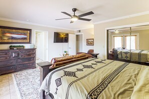 A bedroom with a bed, dresser, mirror, and ceiling fan. - Home w/ Fenced Yard! 2 Mi to Dtwn Casa Grande (Casa Grande)