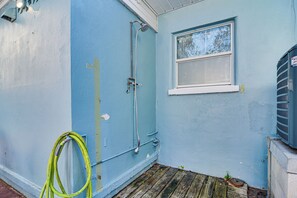 A room with a blue wall, a window, and a door. - Walk to Gulf & Beaches! Indian Rocks Beach Haven (Indian Rocks Beach)