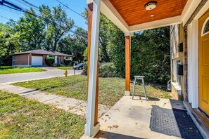 A residential property with a covered porch, a garage, and a front yard. - Cincinnati-Area Condo: Near Shops & Dining (Cincinnati)