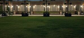 A building with a reception area, outdoor seating, and a well-maintained lawn.