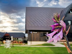 A modern building with a flat roof and a large window. - Plivica Village Etno Garden (Plitvicka Jezera)