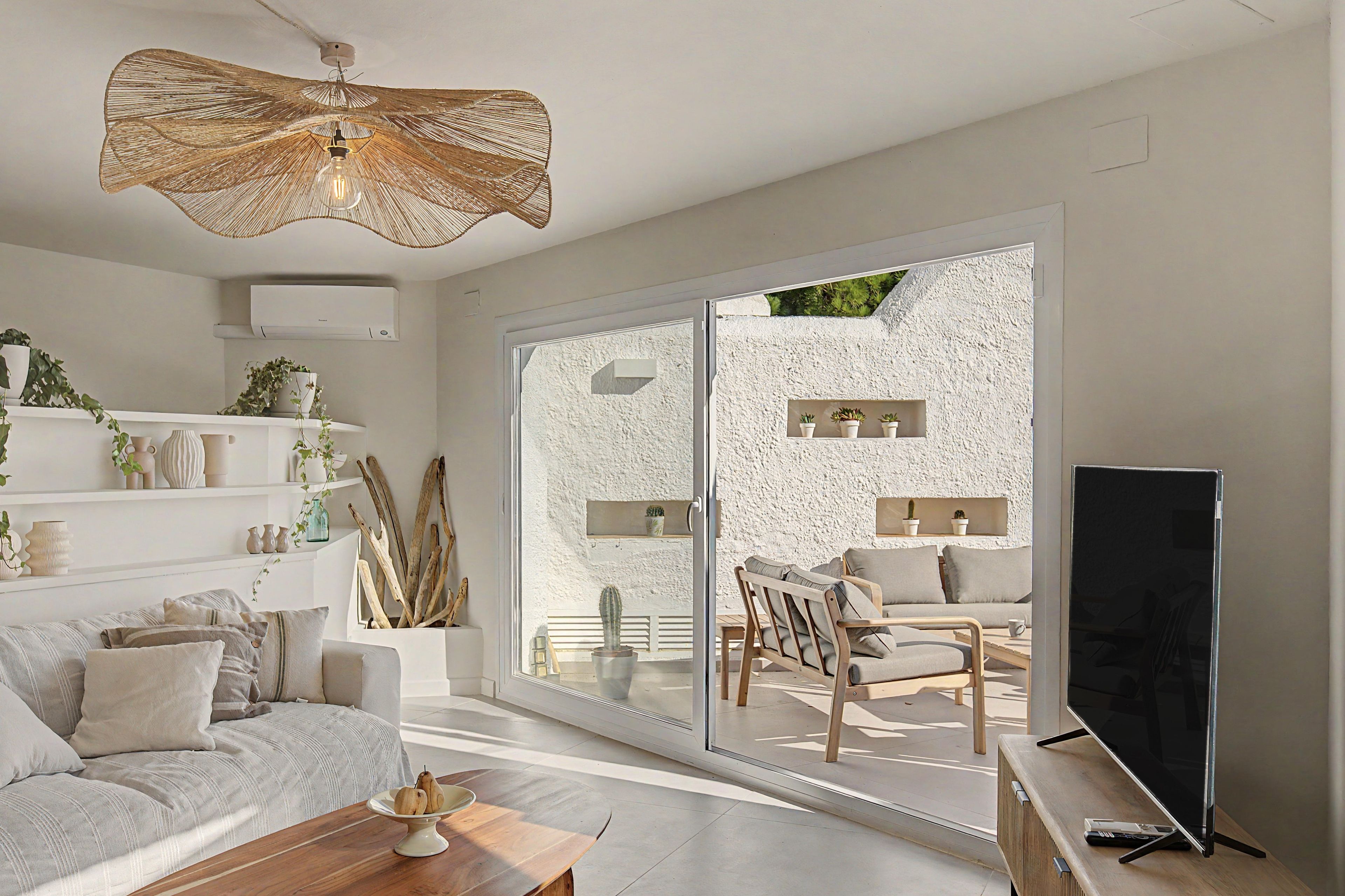 A modern living room with a sofa, coffee table, and a television.