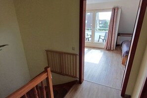 A staircase leading to a balcony with a view of the outside. - Holiday apartment with 2 bedrooms (Cuxhaven)