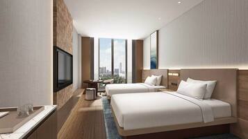 A modern hotel room with two beds, a flat-screen TV, a small table, and a view of the cityscape.