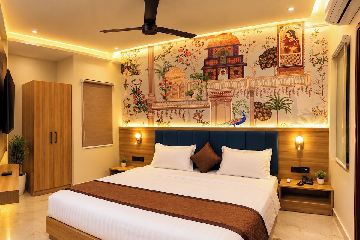 A bedroom with a bed, nightstands, a ceiling fan, a wall with traditional artwork, and a wooden wardrobe.