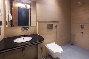 A bathroom with a sink, toilet, and shower.