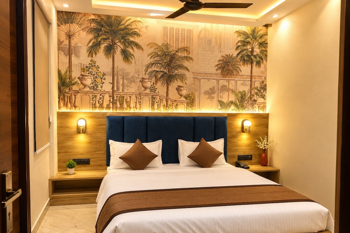 A hotel room with a bed, nightstands, a ceiling fan, and a mural on the wall.