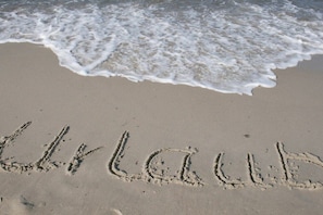 A beach with the word 'LAUBA' written in the sand, waves approaching, and a clear sky. - Villa Käthe "Apartment - 6b" (Kühlungsborn)