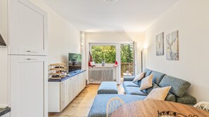A compact living space with a kitchenette, a sofa, and a dining table. - Nevea Lux with Sauna & Kanin View (Sella Nevea)