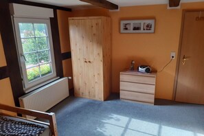 A room with a window, a radiator, a wardrobe, a dresser, and a bed. - Holiday apartment in Jabel with swimming pool (Jabel)
