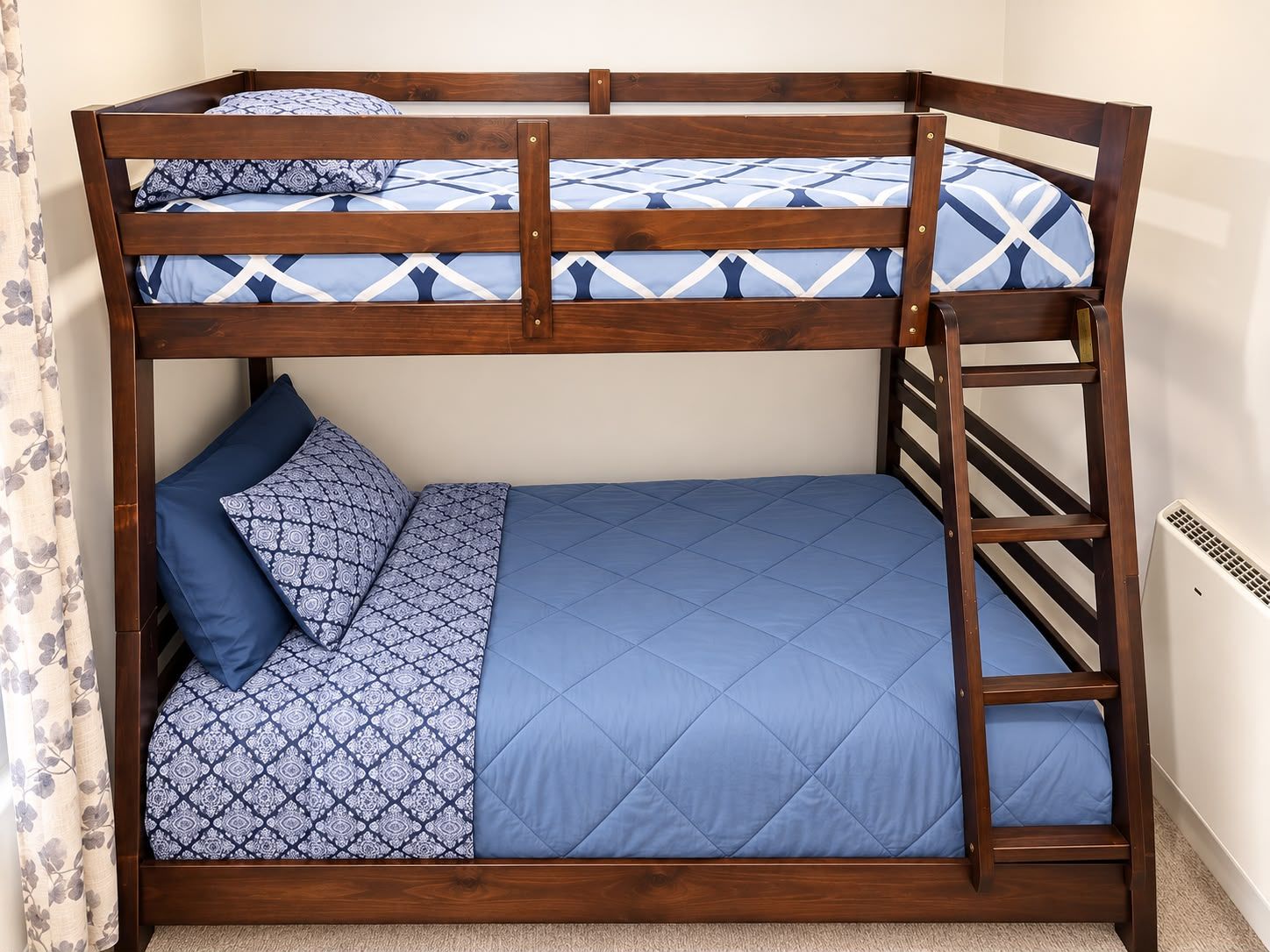 A bunk bed with a wooden frame and blue bedding.