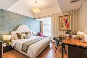 A hotel room with a large bed, a desk, a chair, a lamp, and a painting on the wall. - Westlake Seven Service Apartmentwestlake (Hangzhou)