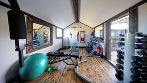 A gym with exercise equipment, a bench, and a mirror. - The Factory (Hapuku)