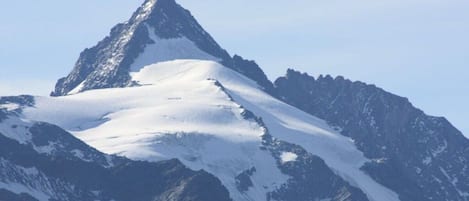 A snow-covered mountain peak with rugged terrain and no visible structures or amenities.