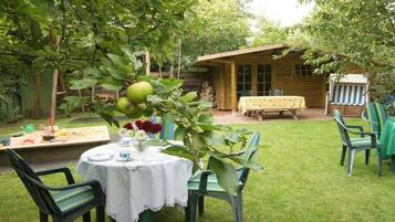 A rustic wooden cabin with a dining area and a table set for a meal.