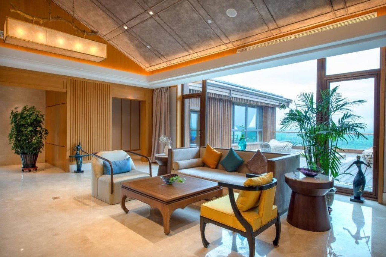 A modern living room with a sofa, armchairs, and a coffee table.