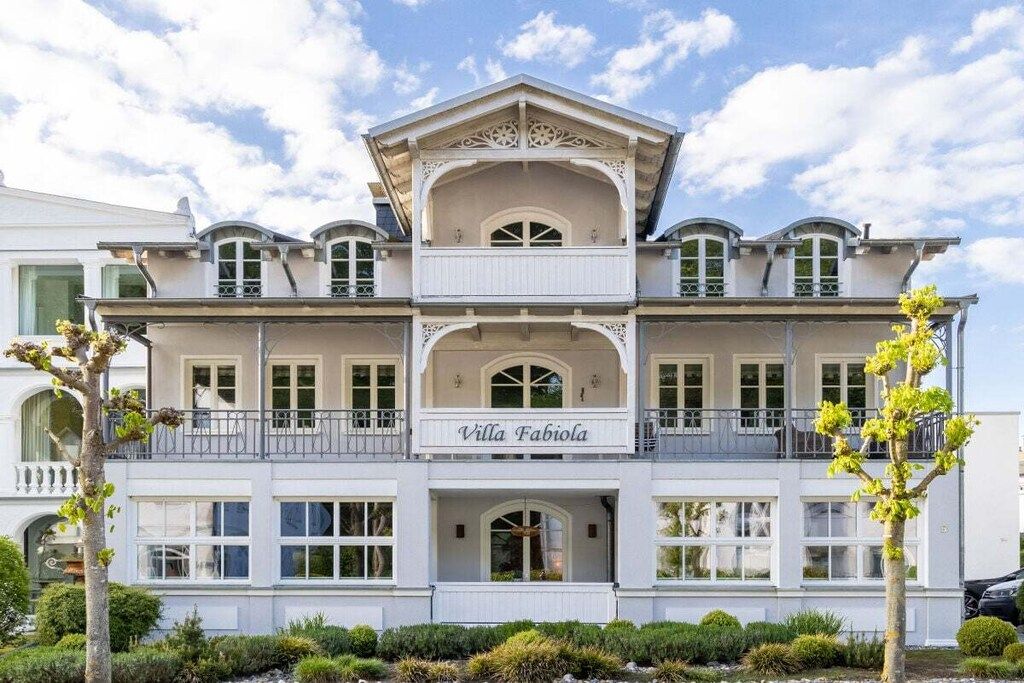 A two-story building with balconies and a sign reading 'Villa Fabiola'.