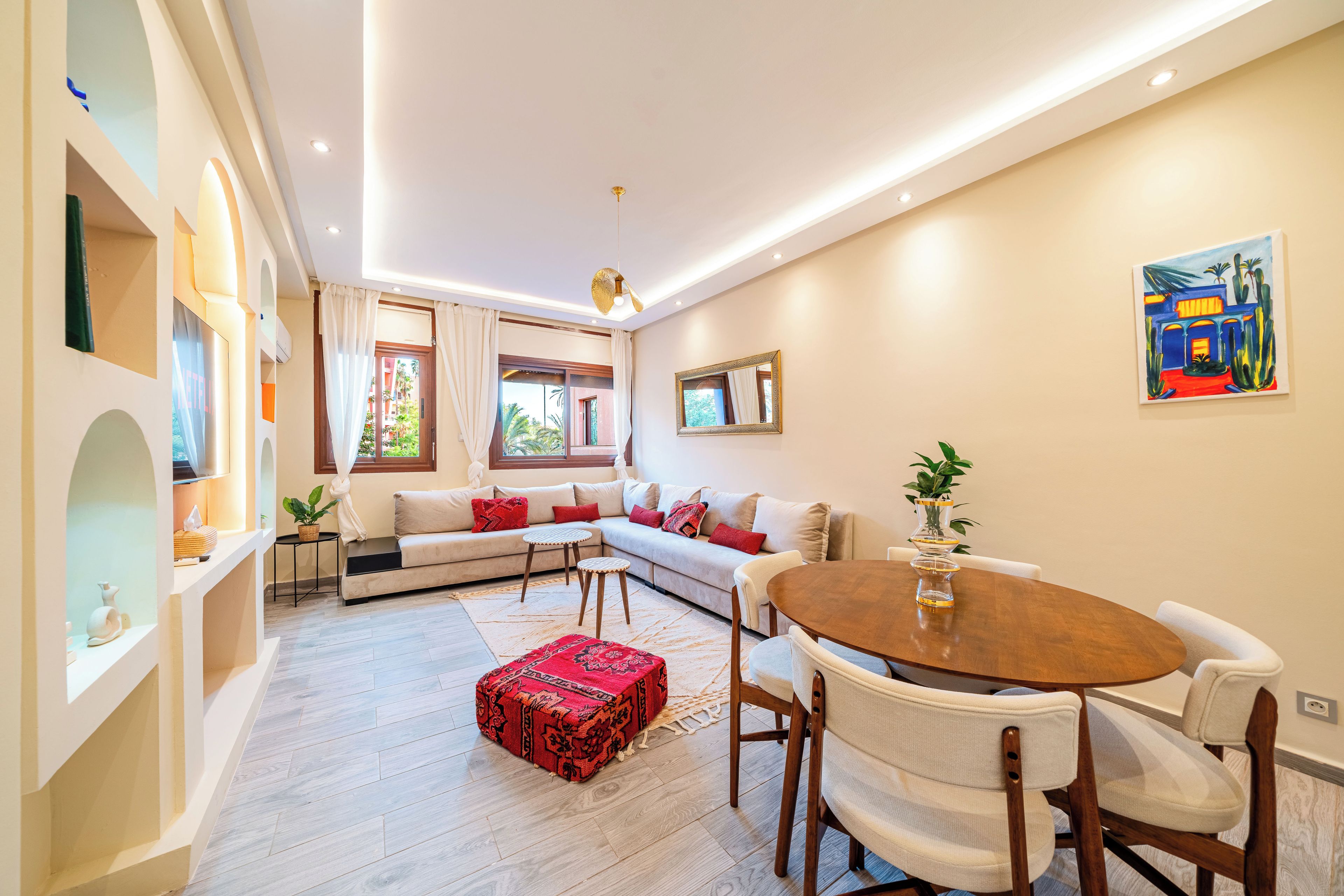 A modern living room with a sofa, a dining table, and a coffee table.