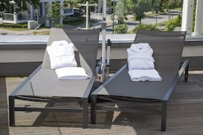 Two sun loungers with towels on a wooden deck, overlooking a landscaped area. - Baltic Cloud at Villa Augustine (Ostseebad Binz)