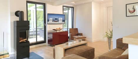 Una sala de estar moderna con chimenea, televisor y sofá.