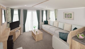 A modern living room with a sofa, a coffee table, a TV, and curtains. - Llanrhidian Holiday Park (Swansea)
