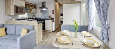 A modern kitchen with a stove, oven, and built-in cabinets.